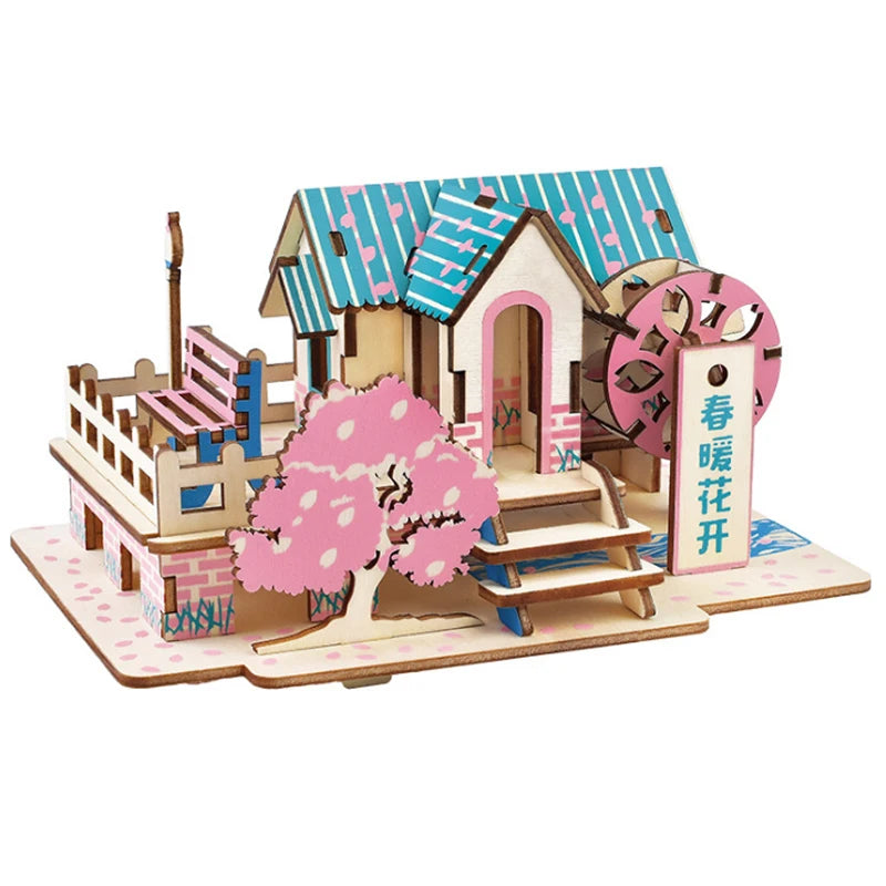 Wooden model of a small house with cherry blossom tree and sign on a white background