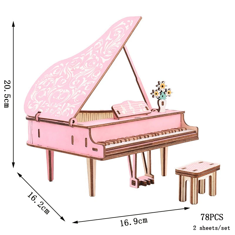 Pink grand piano model kit with dimensions and piece count on a white background